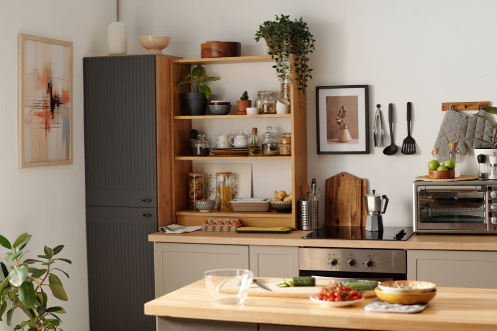 Cozy and organized kitchen with wooden countertops, open shelves, plants and neatly arranged kitchen essentials.