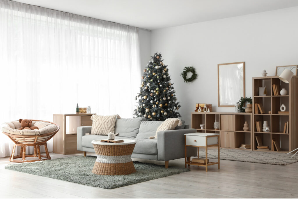 Neutral Christmas decor ideas with a decorated tree, cream cushions and natural wooden furniture.
