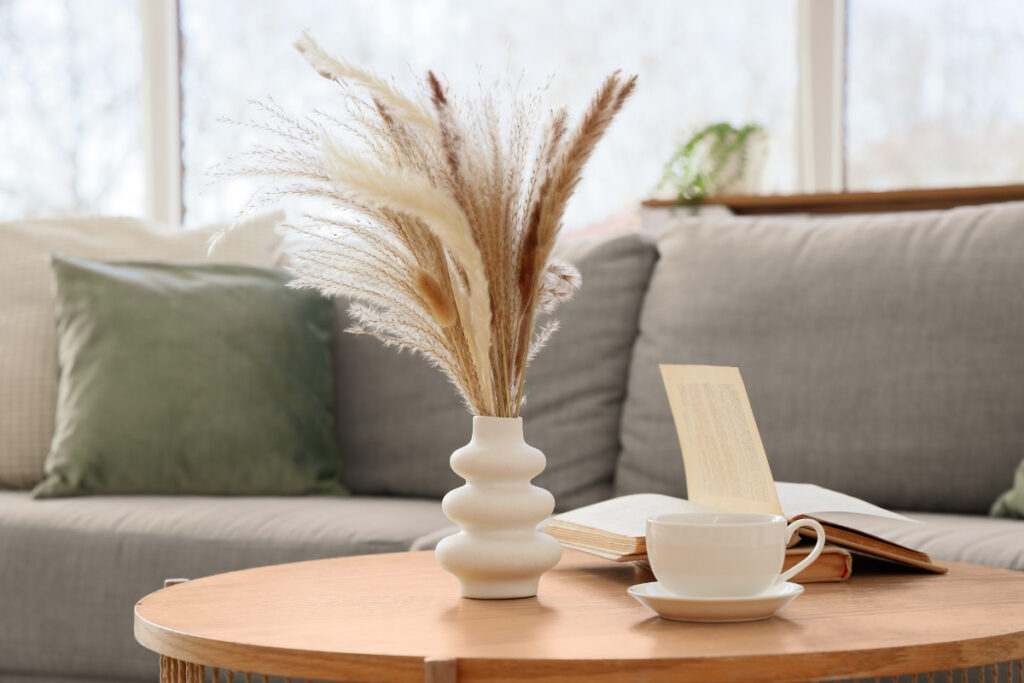 Calm home decor with a ceramic vase, books, and coffee