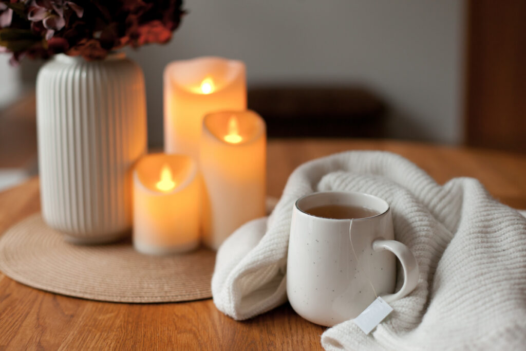 Cozy candles and soft blankets creating a peaceful home atmosphere